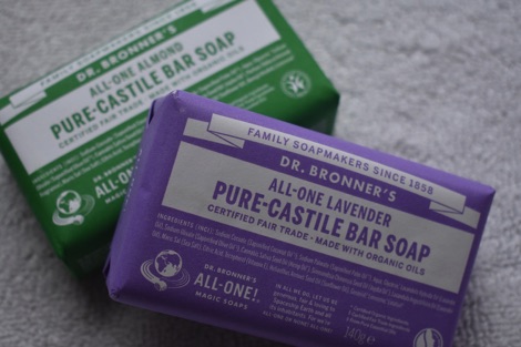 Purple bar of Lavender Dr Bronner's All-One soap resting against green bar of almond Dr Bronner's All-One soap